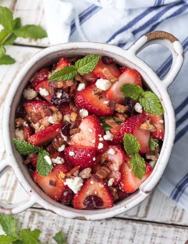 This STRAWBERRY BACON SALAD with HONEY LIME BALSAMIC VINAIGRETTE salad dressing is the perfect salad for summer. Fresh, sweet, savory, and rich, with feta, pecans, and mint on top.