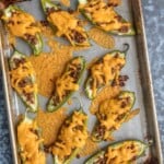 stuffed jalapeno poppers on cookie sheet