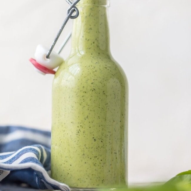 Peruvian Green Sauce (Aji Sauce) is our go-to sauce for anything and everything. We love this Peruvian Green Sauce Recipe on chicken, steak, grilled veggies, salad, and more. SO DARN GOOD. Aji Verde (Green Sauce) is loaded with jalapenos, basil, parmesan, ginger, honey, garlic, lime, and more!