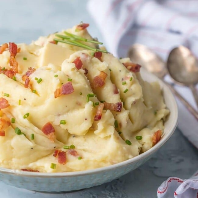 Cheesy Mashed Potatoes with Goat Cheese and Bacon belong on every holiday table! You need these Bacon & Goat Cheese Mashed Potatoes if you're about to entertain friends or family! Bacon Mashed Potatoes are the ultimate side dish. This Mashed Potatoes Recipe is so creamy, flavorful, and delicious. THE BEST cheesy mashed potatoes recipe!