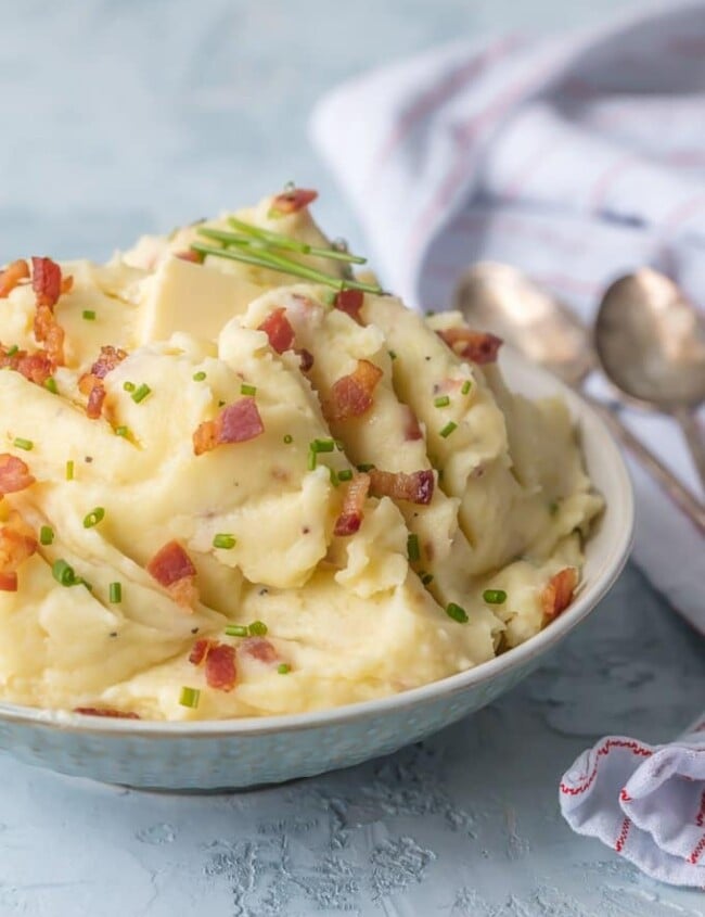 Cheesy Mashed Potatoes with Goat Cheese and Bacon belong on every holiday table! You need these Bacon & Goat Cheese Mashed Potatoes if you're about to entertain friends or family! Bacon Mashed Potatoes are the ultimate side dish. This Mashed Potatoes Recipe is so creamy, flavorful, and delicious. THE BEST cheesy mashed potatoes recipe!