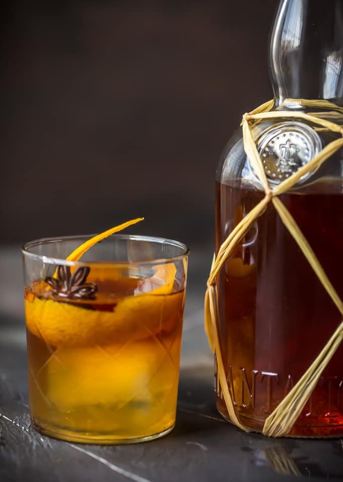 glass of rum next to a bottle of rum