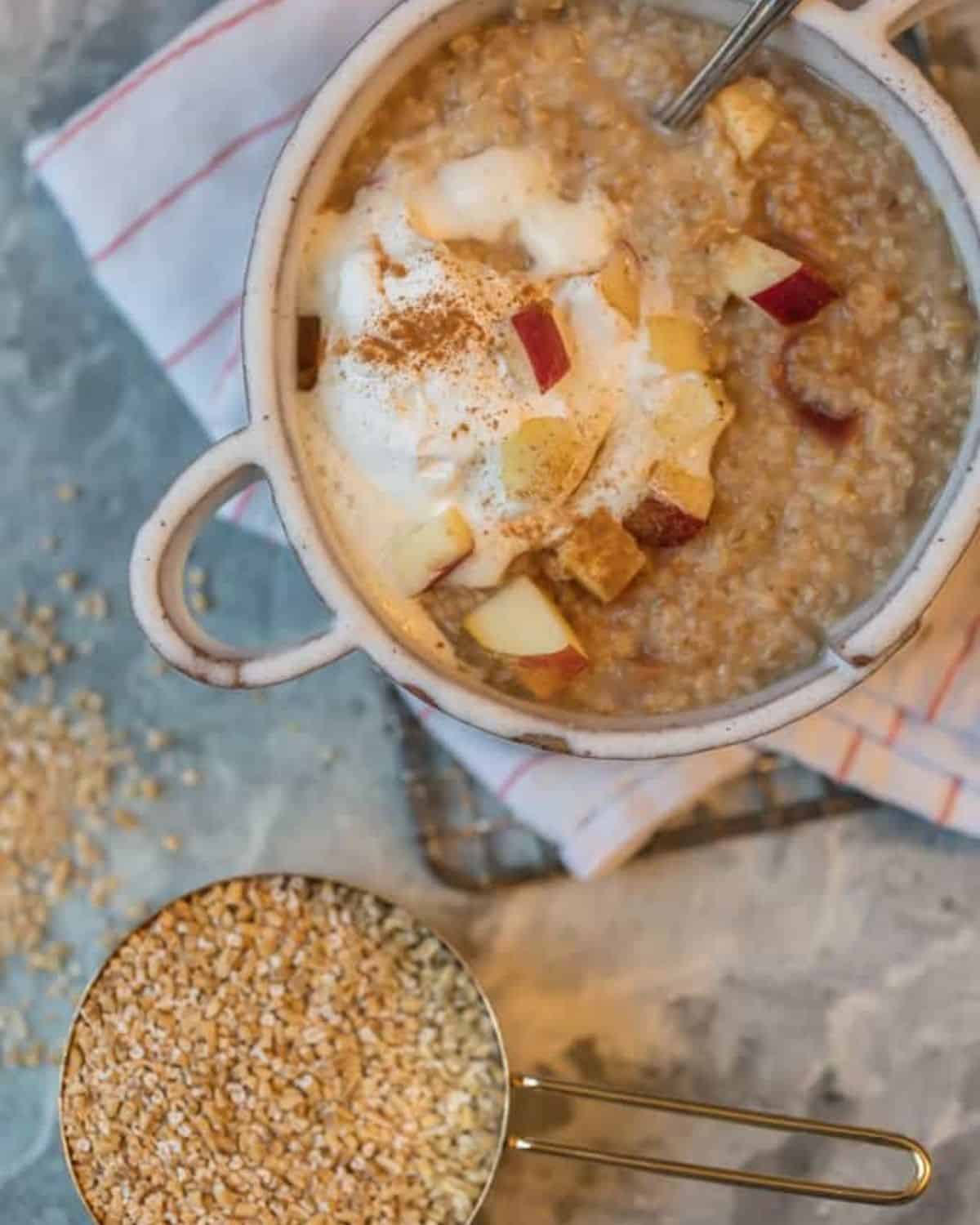 INSTANT POT OATMEAL is so easy to make, so it's perfect for busy mornings. This Instant Pot Apple Pie Oatmeal is made in under 10 minutes, making mornings easy and delicious! Top this tasty apple oatmeal with some fresh whipped cream for an extra special treat. It tastes just like Apple Pie in breakfast form! Instant Pot Apple Pie Oatmeal served
