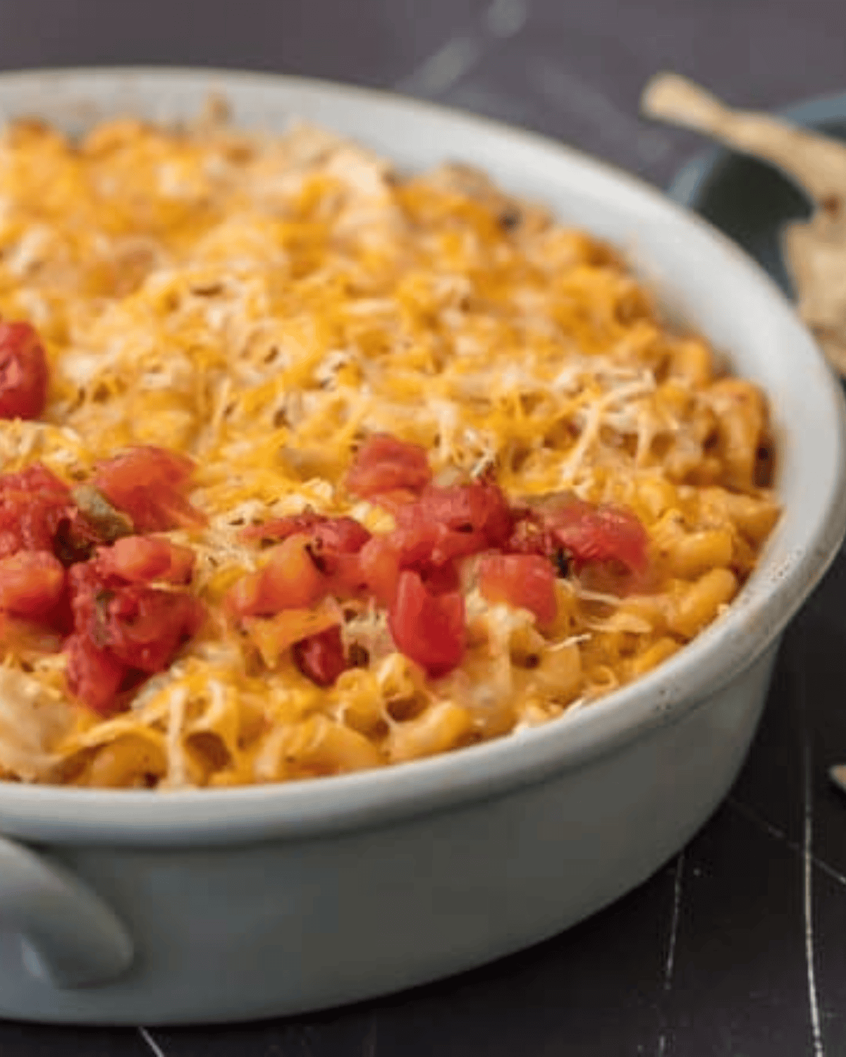 KING RANCH CHICKEN MAC AND CHEESE is a delicious twist on a classic. I wanted to make a fun King Ranch Chicken Recipe that's filled with all those amazing ingredients that I love. This Chicken Mac and Cheese Casserole is loaded with creamy cheese, spicy tomatoes, chunky chicken, and so much more. It will be a family favorite from the first time you make it. finished bowl of king ranch mac and cheese