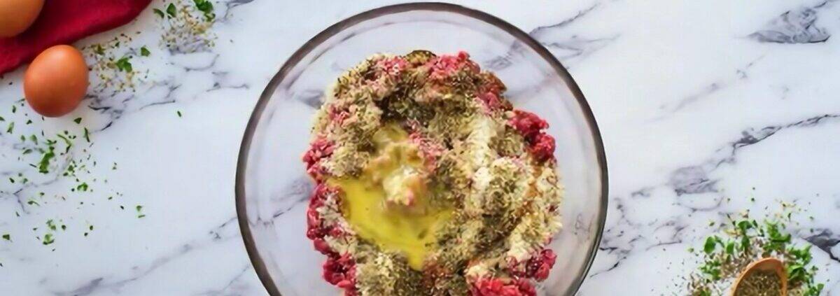 Combining the ingredients for the meatballs.