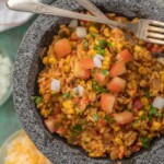 This EASY CHEESY TEX MEX RICE is our favorite Mexican side dish! We are obsessed with this cheesy rice loaded with all the best ingredients.