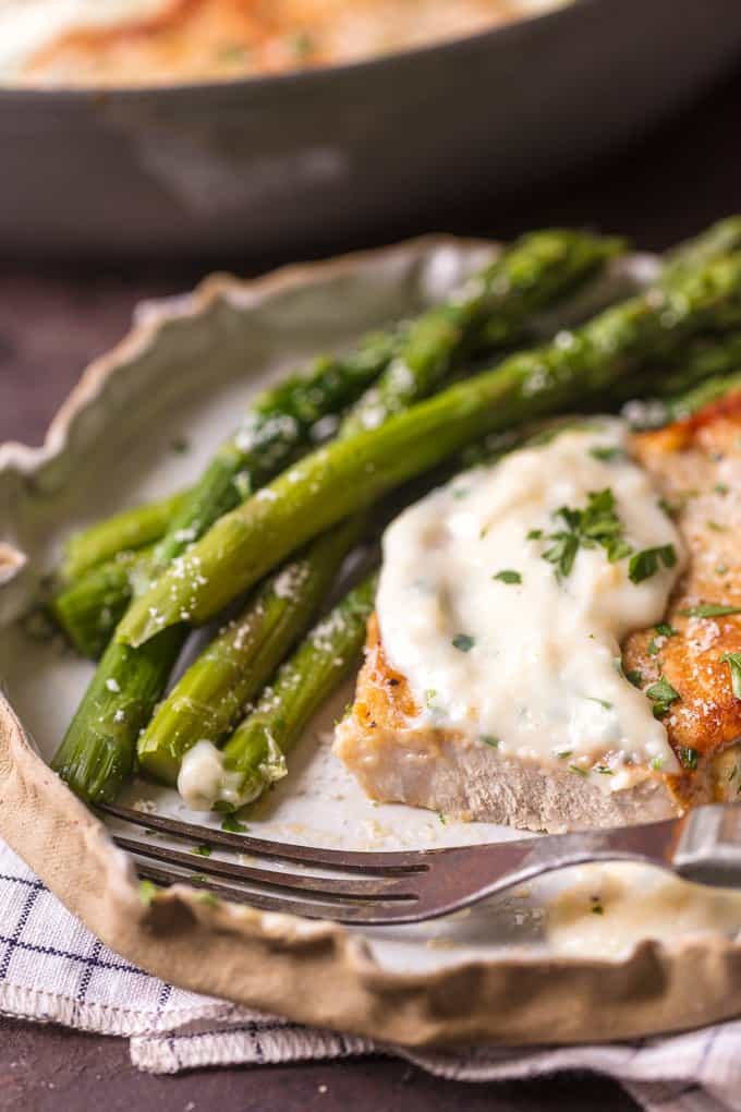 Parmesan Pork Chop on a plate with asparagus