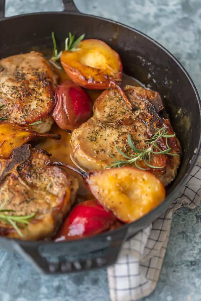 Pan fried pork chops in a skillet with bourbon pears