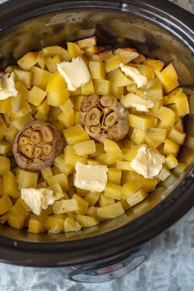 Potatoes, garlic, and butter in a crock pot