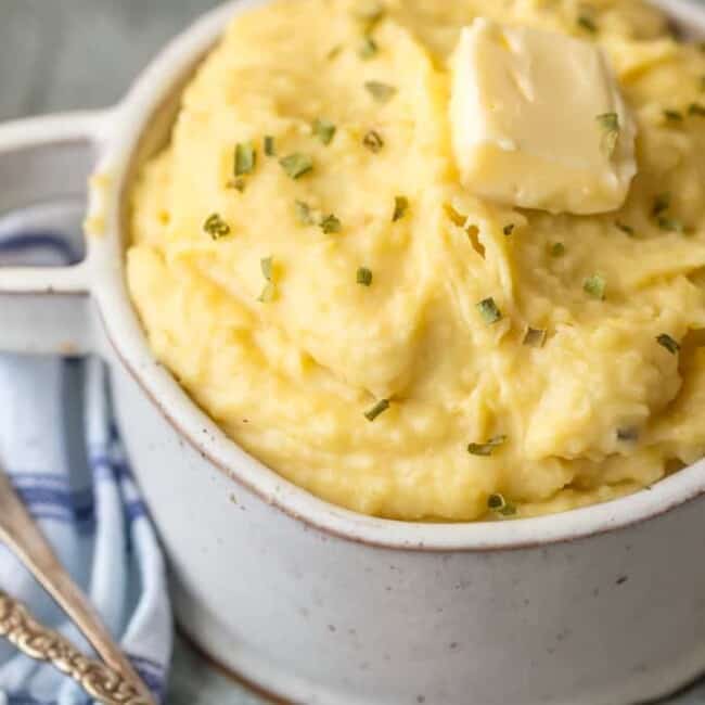 Slow Cooker Mashed Potatoes with Garlic Butter are one of the easiest and best side dishes for any dinner or holiday. These Crock Pot Mashed Potatoes are the perfect EASY Thanksgiving, Christmas, or Easter side dish. So much flavor and none of the fuss. Making this Roasted Garlic Mashed Potatoes recipe in a Crock Pot is SO EASY! Creamed Potatoes for the win!