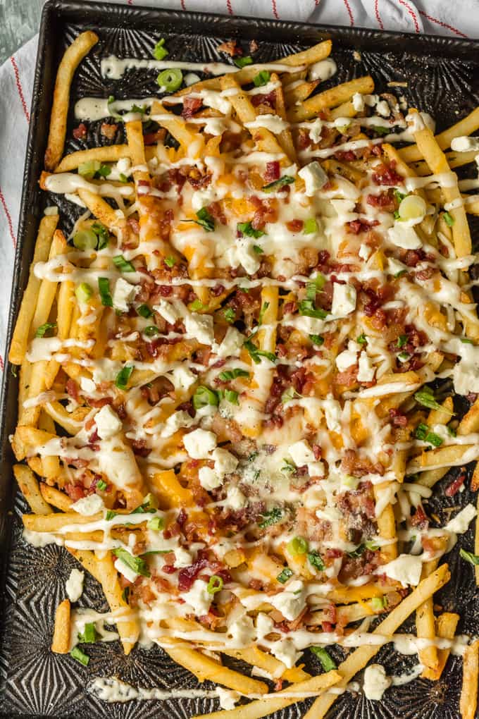 Â Bacon Cheese Fries with Ranch are myÂ  go-to party food.Â This Cheese Fries RecipeÂ is sure to make game day easy and delicious! This easy and fun appetizer takes crispy fries and tops them with ranch seasoning, bacon, cheddar, mozzarella, and feta. 3 Cheese Fries with Bacon and Ranch for the WIN!