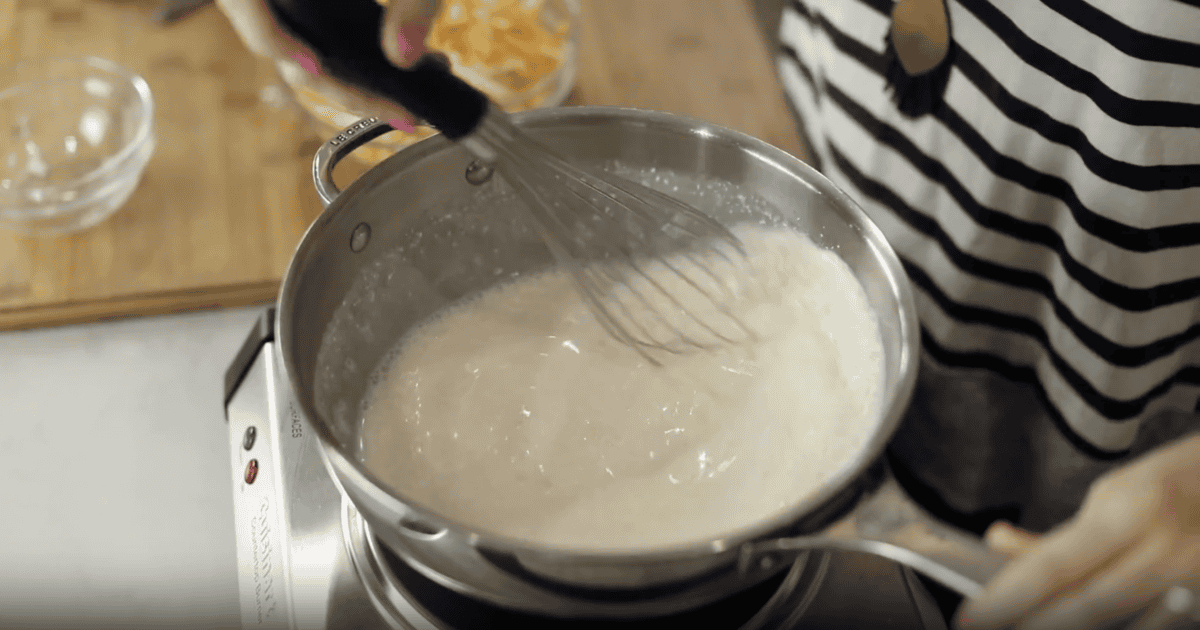 melted cream cheese and beer in a saucepan with a whisk.