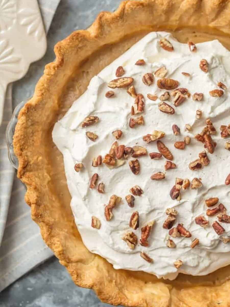 A pecan pie with whipped cream and butterscotch.