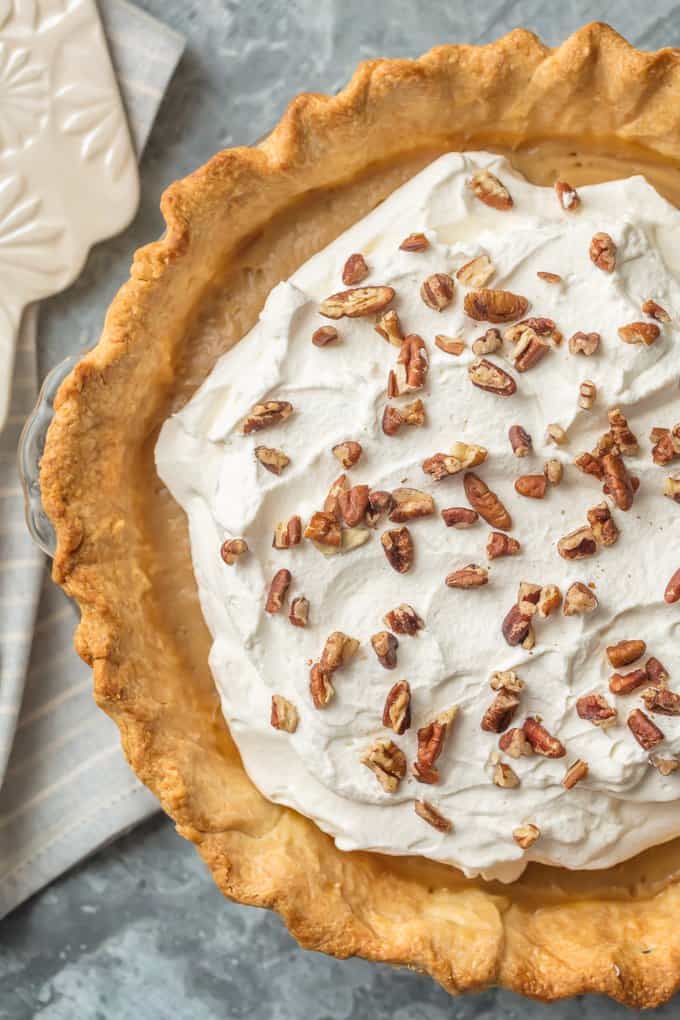 overhead view of a butterscotch pie topped with whipped cream
