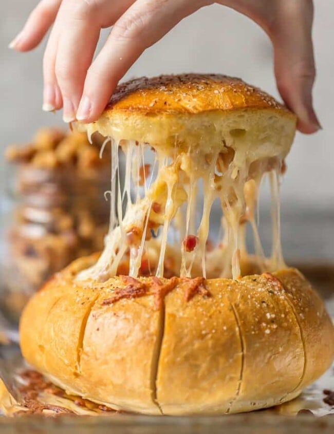 This BAKED BRIE RECIPE is A MUST at your holiday table! This Baked Brie Bread Bowl Recipe with Bacon and Candied Walnuts is the ultimate holiday appetizer that all cheese lovers will devour! A Baked Brie Bowl loaded with candied walnuts and crispy bacon is SO easy and full of flavor. Best easy appetizer recipe!