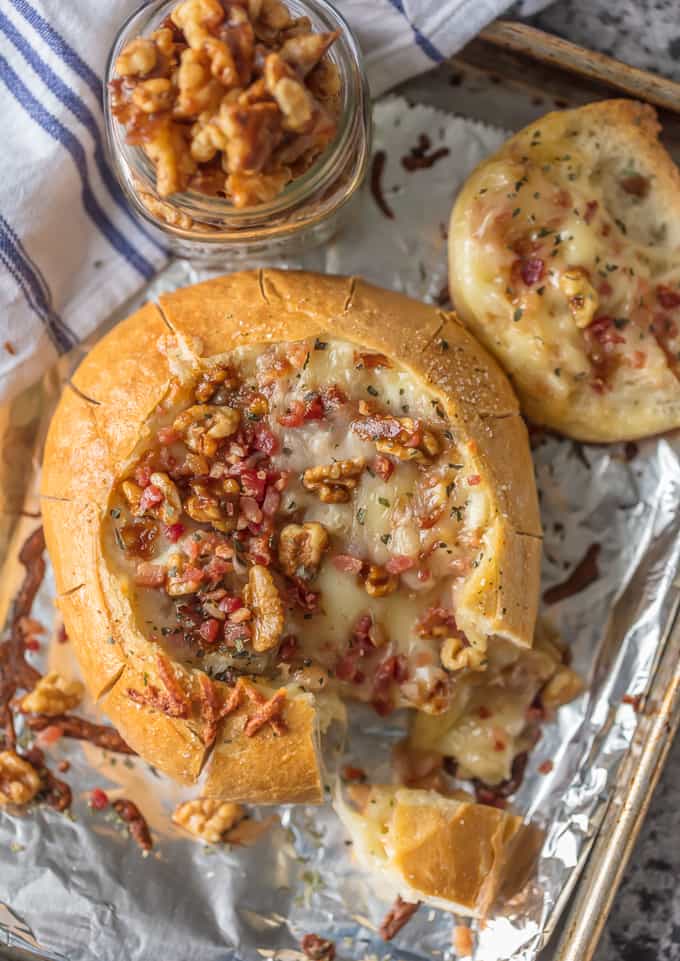 Baked Brie Recipe with bacon and candied walnuts inside of a bread bowl