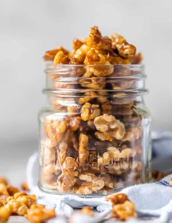 Walnuts in a glass jar with a spoon - candied walnuts.