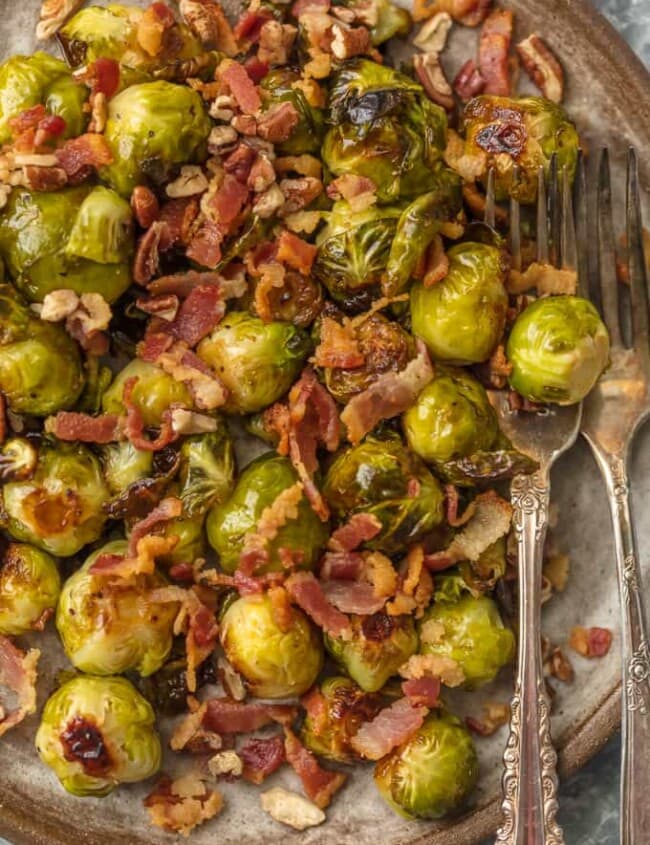 These CRUNCHY BACON PECAN BALSAMIC BRUSSELS SPROUTS are the ultimate way to eat veggies this Thanksgiving. Everyone (even the kids) loves brussels sprouts when they're cooked with this much flavor.