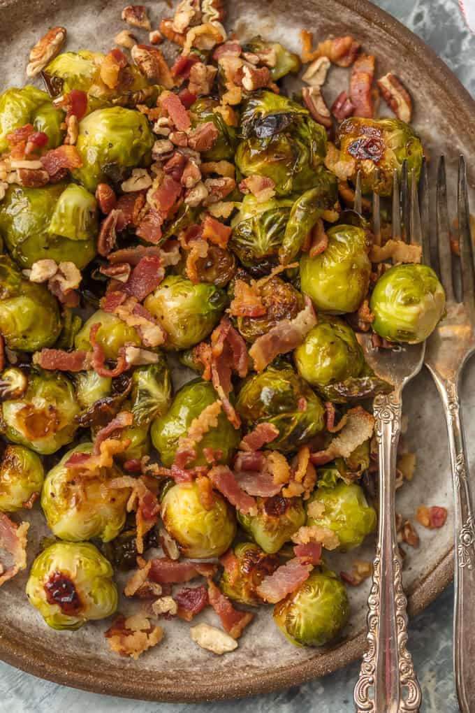 green brussel sprouts on a plate and bits of bacon and pecans