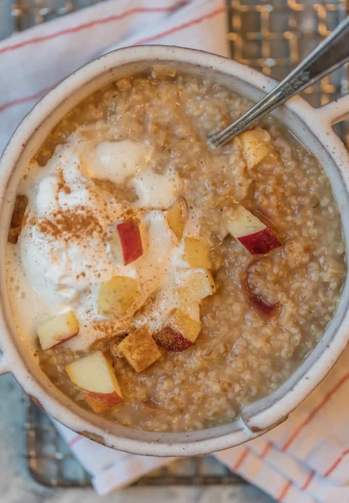 Instant Pot Apple Pie Oatmeal in a bowl, topped with cream and cinnamon