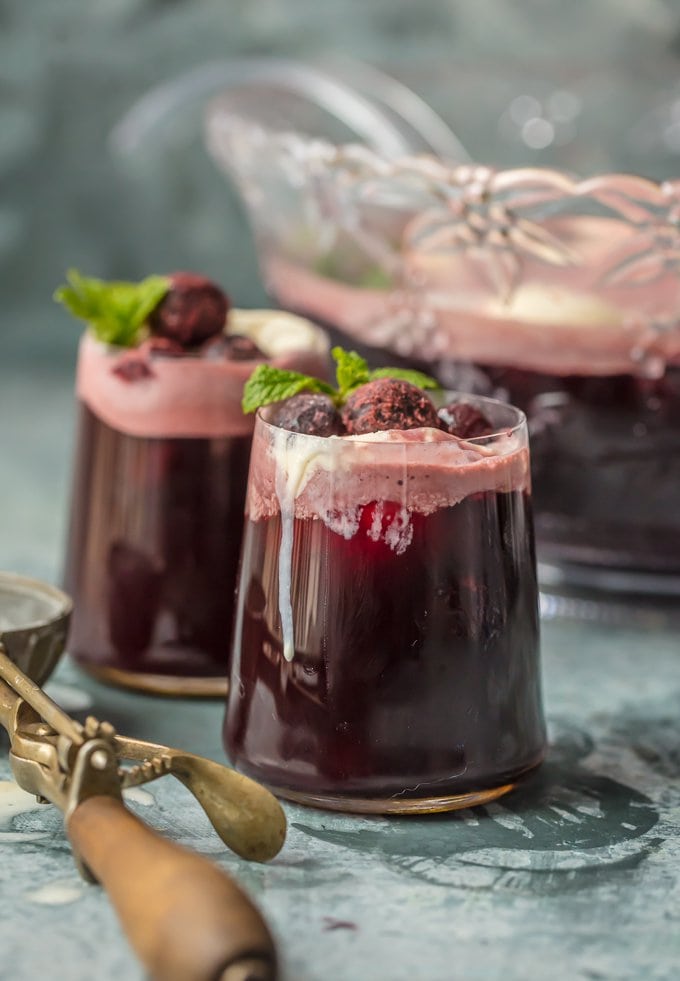 Easy Party Punch recipe in 2 glasses, next to a punch bowl