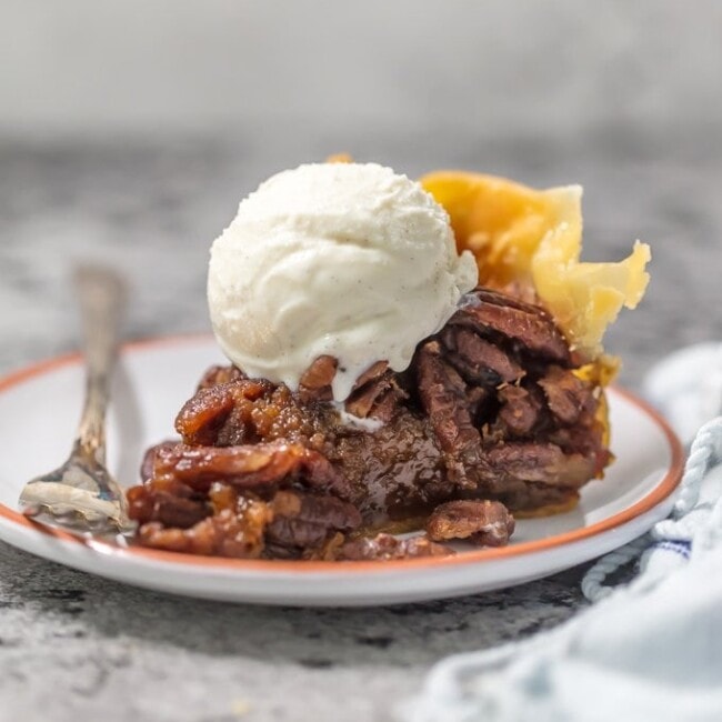 This SLOW COOKER PECAN PIE will knock your socks off and make for a delicious and easy Thanksgiving, Christmas, or Easter! We LOVE Pecan Pie and it's just as delicious made in a crockpot!