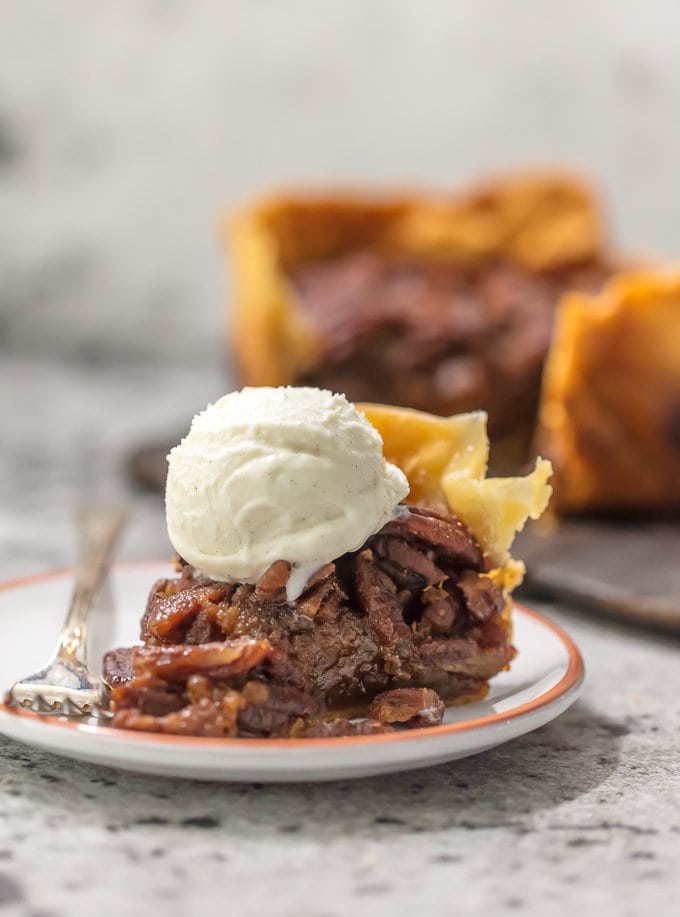 This SLOW COOKER PECAN PIE will knock your socks off and make for a delicious and easy Thanksgiving, Christmas, or Easter! We LOVE Pecan Pie and it's just as delicious made in a crockpot!