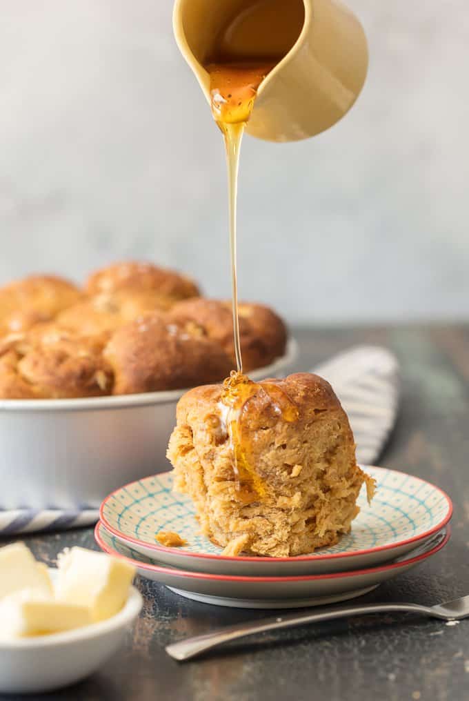 drizzling honey over a bread roll