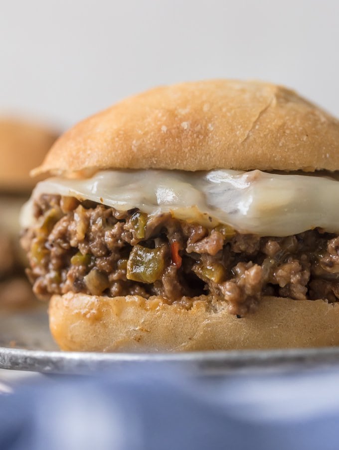 up close picture of philly cheesesteak sloppy joes with melted cheese on brioche