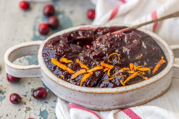 Homemade Cranberry Sauce in a serving dish on a white dish towel