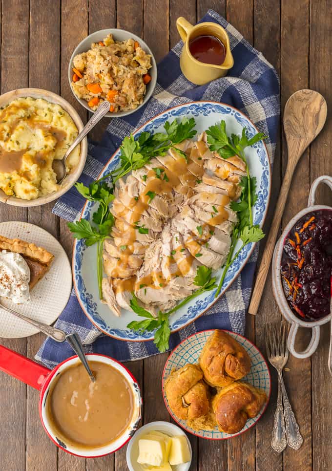 thanksgiving spread with turkey, potatoes, cranberry sauce, and more
