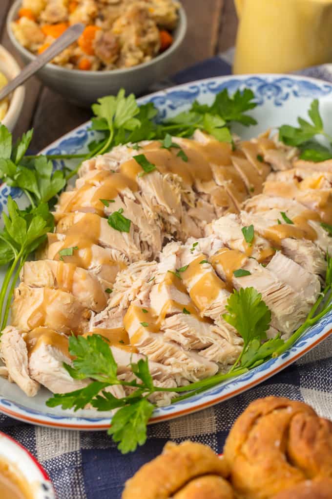 Best turkey breast recipe on a serving platter, covered in turkey gravy