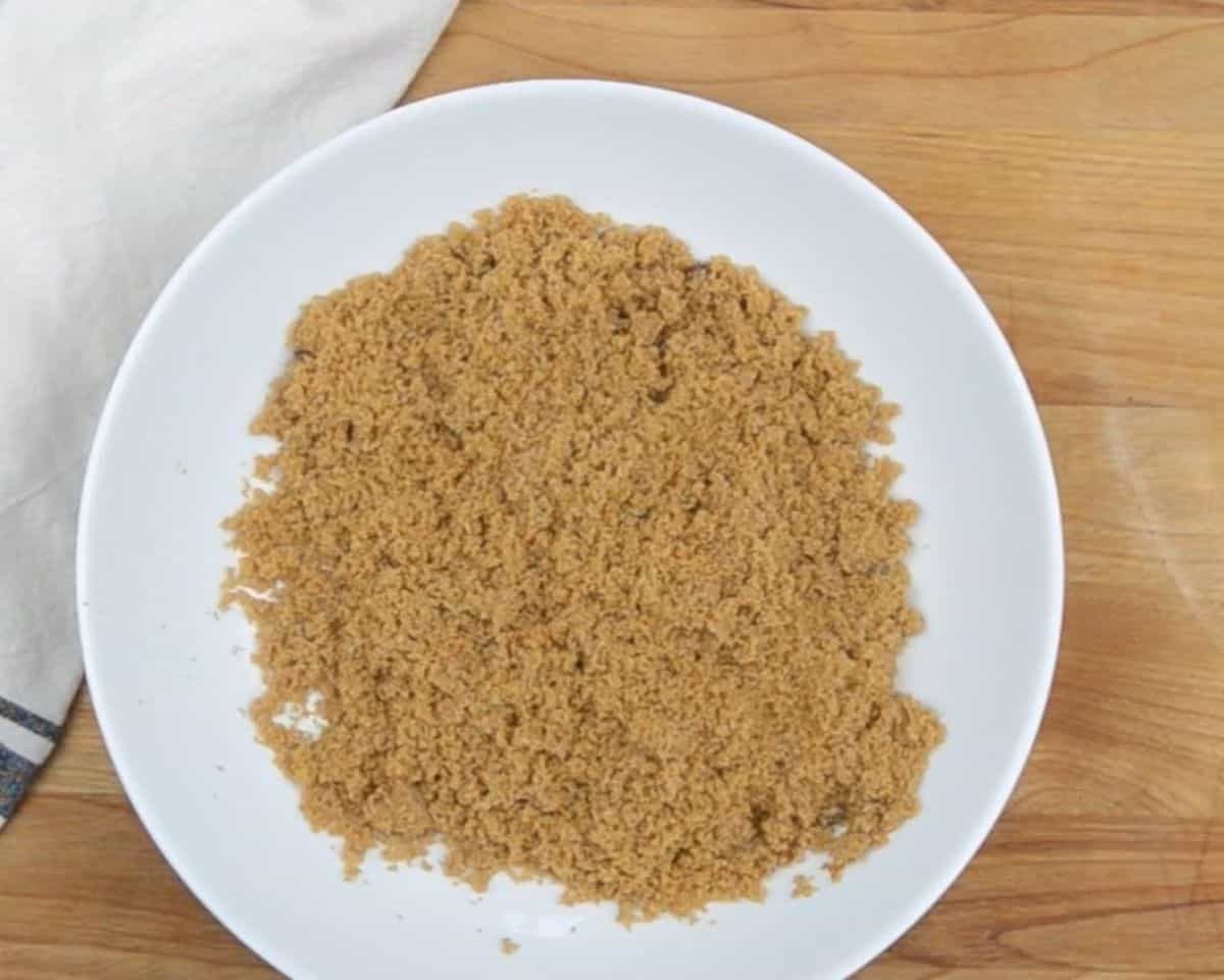 Brown sugar on a white plate.