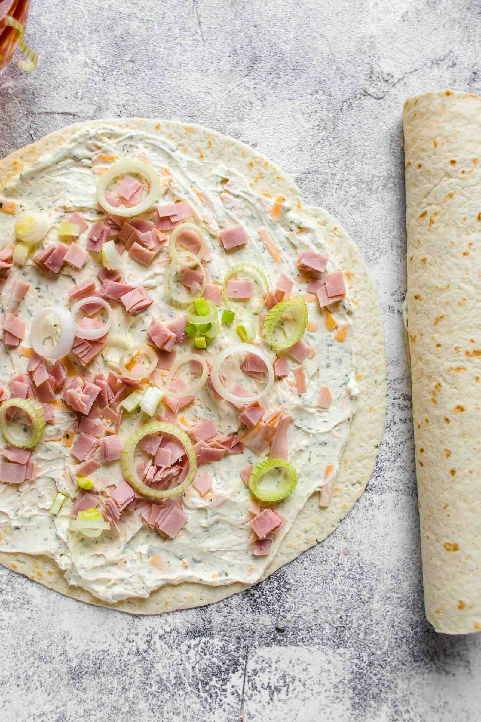 a tortilla covered in the ingredients used to make the roll up