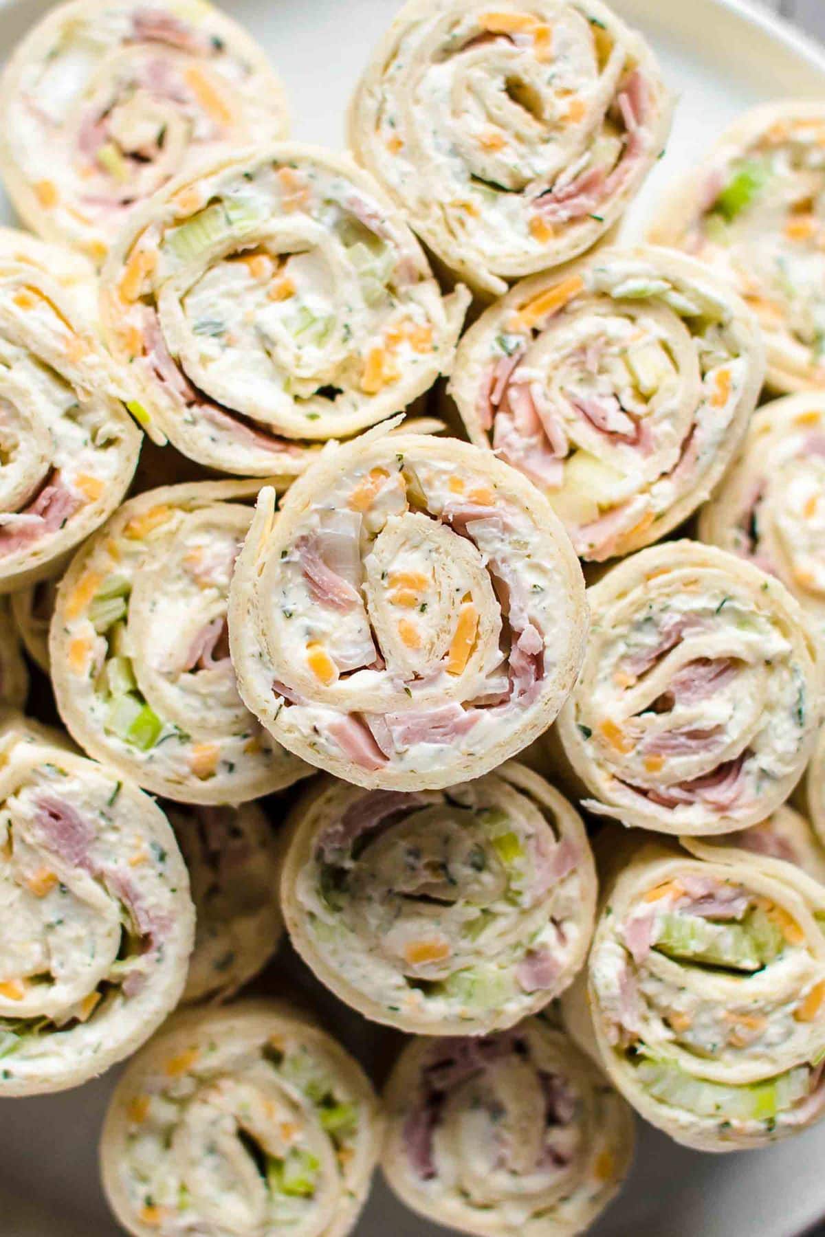 side view of several ham and cheese tortilla roll ups