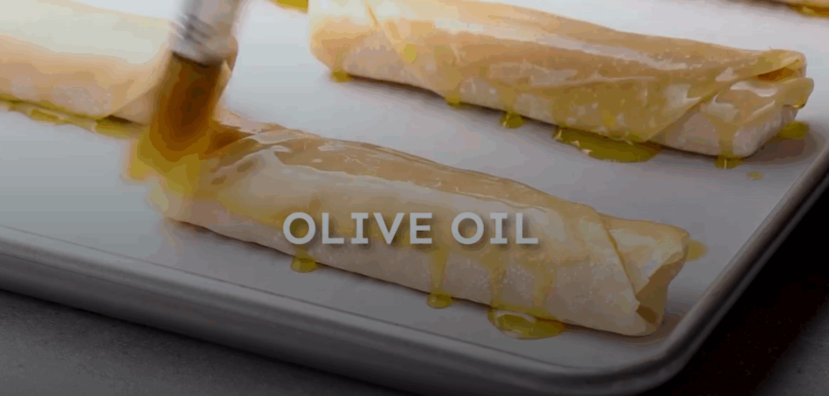 Brushing the cheese sticks with olive oil. 
