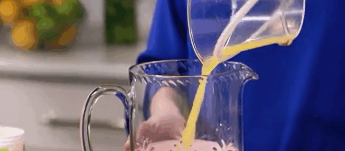 Adding orange juice to the strawberry mixture. 