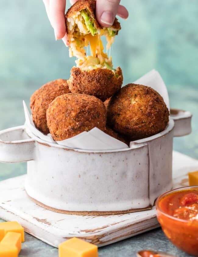 These Arancini Balls with Cheese Bacon and Broccoli are so much easier than you might think. This Arancini Recipe is one of our favorite comfort food appetizers! These cheesy fried rice balls (Arancini Balls) are the ultimate starter to any meal at home. So addicting and delicious!