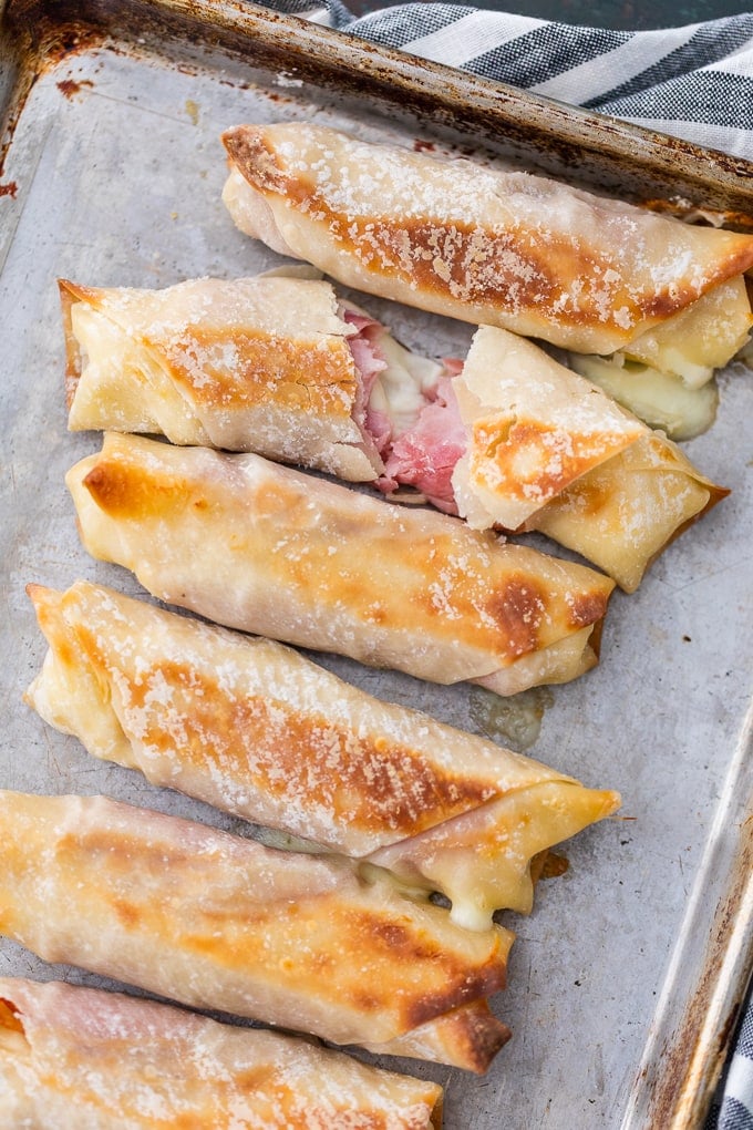 Baked Mozzarella Sticks filled with ham & cheese on baking tray