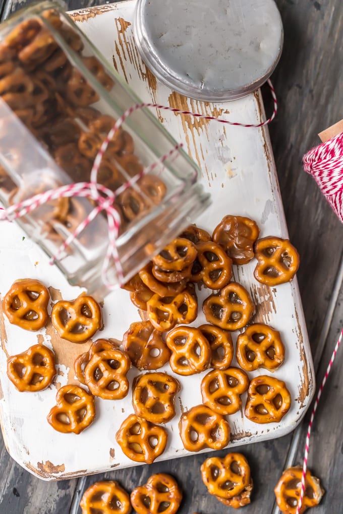 Mini toffee pretzels spilling out of glass jar