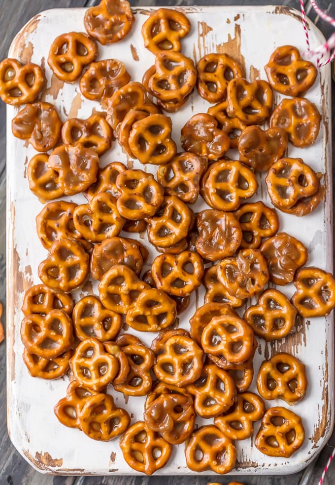 Butter toffee pretzels arranged on a white board