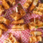 This Mini Chicken and Waffles Recipe is such a cute and delicious appetizer. These MINI CHICKEN AND WAFFLES ON A STICK are so fun and perfect for celebrating! Whether its the holidays or game day, these will wow any crowd. I love that these Mini Chicken and Waffles are the perfect size. So delicious with syrup!