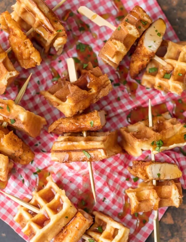 This Mini Chicken and Waffles Recipe is such a cute and delicious appetizer. These MINI CHICKEN AND WAFFLES ON A STICK are so fun and perfect for celebrating! Whether its the holidays or game day, these will wow any crowd. I love that these Mini Chicken and Waffles are the perfect size. So delicious with syrup!