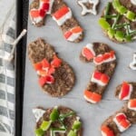 sheet pan of Sausage "cookies" - breakfast sausage shaped with cookie cutters and decorated with red and green peppers
