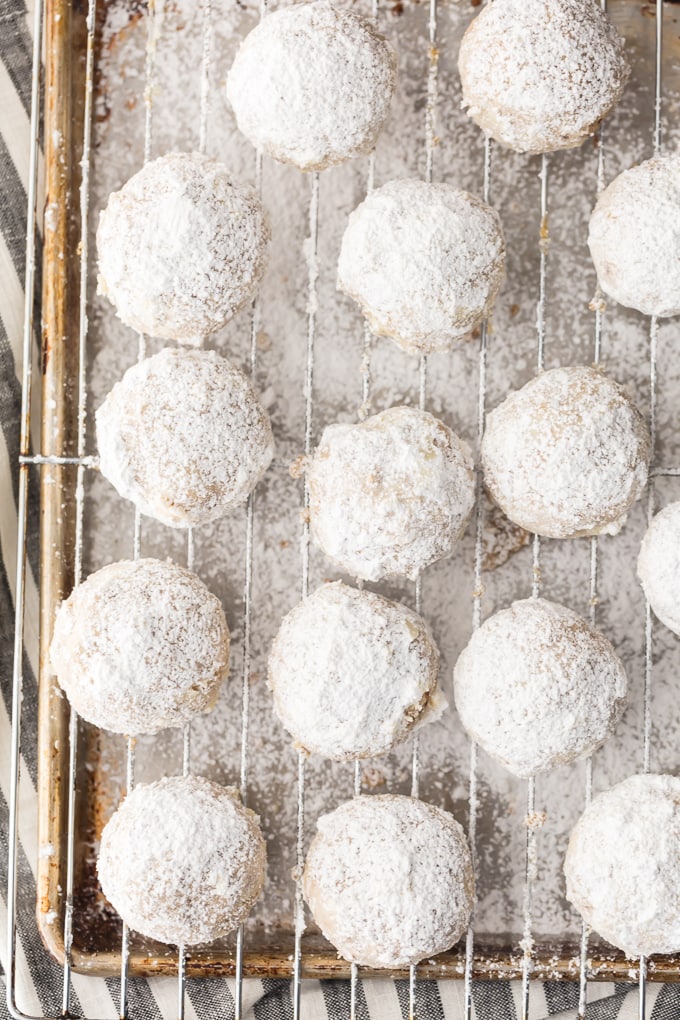 overhead photo of NUTELLA STUFFED SNOWBALL COOKIES on a wire cooling rack