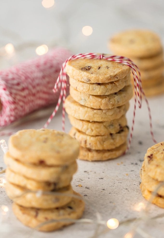 Cranberry Orange Shortbread cookies in stacks with red and white twine
