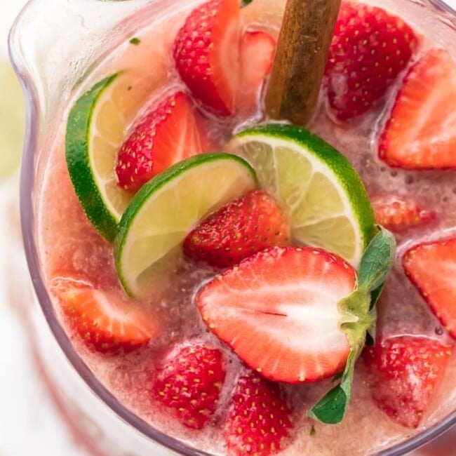 This fun and festive SPARKLING STRAWBERRY MARGARITA PUNCH is such a delicious and easy party drink recipe. Strawberry Limeade meets Margaritas in the most amazing beverage. If you like Strawberry Margaritas, you'll LOVE this Margarita Punch. Cheers to New Years Eve, Cinco De Mayo, and more!
