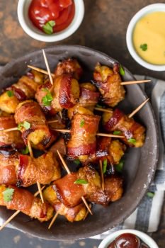 Bacon Wrapped Tater Tots are a must make appetizer for any celebration. You should make a triple batch of these SWEET & SPICY BACON WRAPPED TATER TOTS because they're always gone in seconds! Spices and and a little sweetness make this easy bacon wrapped appetizer a favorite for the holidays and tailgating. Tater Tots have never been better. SO ADDICTING!