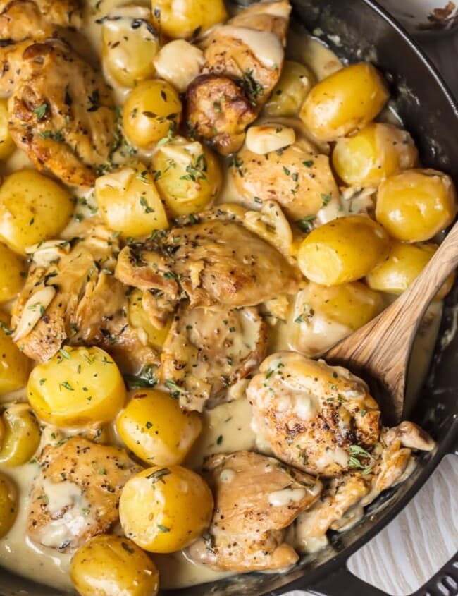 40 Clove Garlic Chicken and Potatoes with Cream Sauce has totally and completely rocked my world. We are obsessed with this Chicken with 40 Cloves of Garlic! Garlic Chicken and Potatoes with Cream Sauce is all the rage right now...so why not add some garlic (or 40 cloves of garlic, to be exact) for the ultimate Garlic Chicken and Potatoes? This is the best chicken recipe of all time!