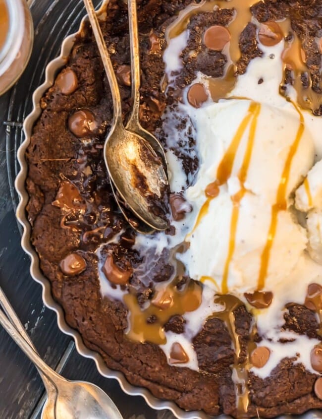 This GIANT COOKIE RECIPE is perfect for SHARING! Similar to those incredible skillet cookies you find at restaurants, our giant CHOCOLATE CARAMEL COOKIE recipe is the stuff dreams are made of! This is our favorite oh so decadent dessert to make for any and every celebration. Gooey chocolate caramel cookies for the win!